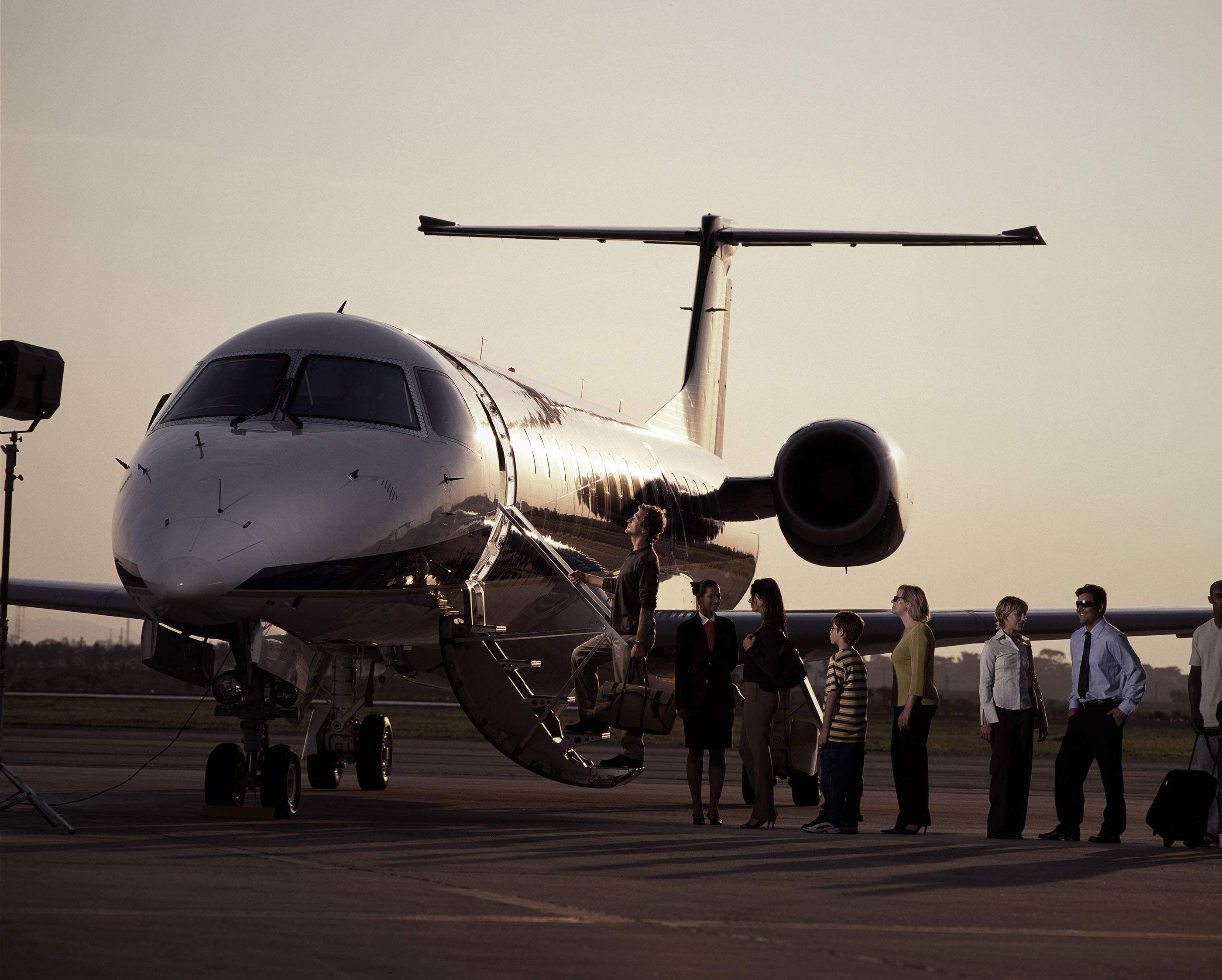 People boarding an Embraer ERJ Runway Legend